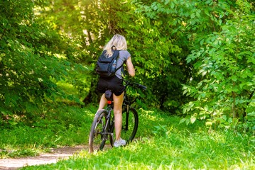 Wall Mural - Cyclist ride on the bike path in the city Park
