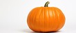 © vxnaghiyev - Close-up shot of an orange pumpkin against a white backdrop with ample copy space image.