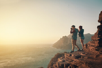 Wall Mural - Hiking, photography and couple on mountain for love, landscape and adventure or travel. Tourists, woman and man in nature or countryside for vacation together with camera in morning for memory