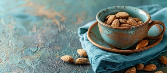 Aufkleber - Copy space image of an almond in a ceramic cup set on a blue napkin.