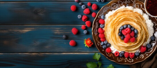 Aufkleber - Top view copy space image of European holiday Maslenitsa with traditional thin crepes adorned with berries, jam, and honey on a blue wooden table.