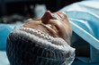 © Seventyfour - Close up of mature female patient lying on operating table preparing for surgery copy space