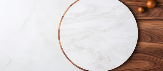 Wall Mural - Circular wooden pizza platter on a white stone kitchen table, seen from above with space for text or images in the middle. with copy space image. Place for adding text or design