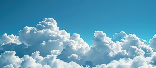 Canvas Print - White fluffy clouds float in a clear blue sky providing a perfect textured background with ample copy space image for text.