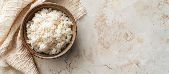 Poster - Top view of a bowl of boiled rice on a light background with ample copy space image.