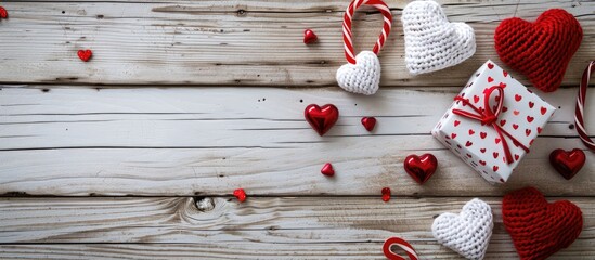 Poster - Heart and gift decorations in red and white on a wooden backdrop with copy space image.