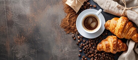 Poster - Coffee beans, croissants, and a cup of coffee on a table with copy space image.