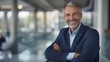 © Achmad Khoeron - portrait of successful senior businessman consultant looking at camera and smiling inside modern office building