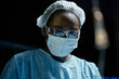 © Seventyfour - Dramatic low angle portrait of young African American woman as surgeon performing surgery in blue lights copy space