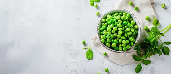 Wall Mural - Top view of fresh organic raw green peas with plant leaves in a bowl on a napkin against a white background, perfect for a copy space image showcasing healthy vegan and vegetarian legume food and