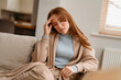 © Iryna - Frustrated Woman Sitting On Couch With Worried Expression