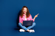 © deagreez - Full body portrait of pretty young lady laptop point finger empty space wear shirt isolated on dark blue color background