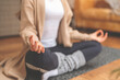 © Iryna - Woman Meditating in Comfortable Home Setting During Day