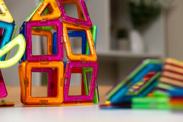 Magnetic constructor buildings on the table. Educational toys