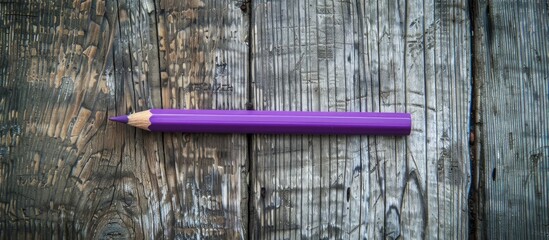 Aufkleber - An aerial shot of a purple pencil and paperclip on a wooden backdrop with space for an image. copy space available