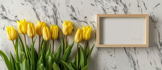 Poster - Copy space image featuring yellow tulips displayed with a white marble background and a blank picture frame.