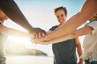 © Stratford/peopleimages.com - Beach, stack and friends with hands together, summer and travel with support, team building and closeup. Group, seaside and men with women, ocean or cooperation with holiday, getaway trip or break