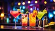 © Uzair - Cocktails on a counter in a bar, lit up by party lights, with a blurred background and copy space. Drink of the tropics. celebrations, nightclubs, bars, and holidays.