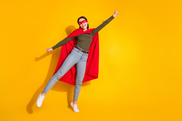 Sticker - Full length photo of lovely teen lady flying superman costume dressed stylish khaki garment isolated on yellow color background