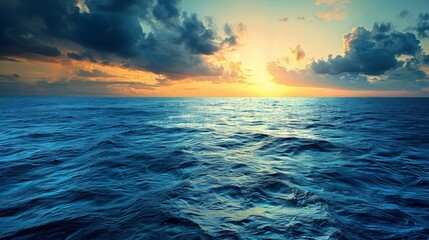 Wall Mural - Panoramic view of the deep blue ocean with a dramatic sunset, casting golden hues across the water