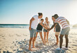© Stratford/peopleimages.com - Beach, stack and group with hands together, travel and vacation with support, team building and nature. Friends, seaside and men with women, ocean or cooperation with holiday, getaway trip or journey