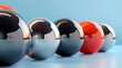 © Design - Row of metallic spheres with one red sphere.