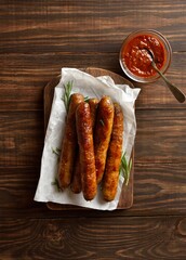 Canvas Print - Roasted juicy sausages on wooden background