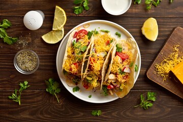 Canvas Print - Tacos with vegetables, chicken meat and cheddar cheese over wood