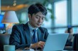 © siripimon2525 - Portrait of a Japanese business traveler working on a laptop in the airport lounge, high quality photo, photorealistic, focused expression, studio lighting