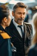 © siripimon2525 - Portrait of a European pilot talking to ground crew in the terminal, high quality photo, photorealistic, confident expression, well-lit environment