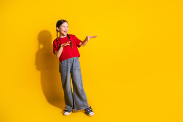 Poster - Full size photo of lovely small girl good mood dance empty space wear t-shirt isolated on yellow color background