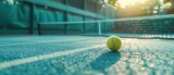 Tennis court with net and ball in focus, sports highlight background, text overlay spot