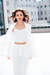 © halayalex - Young beautiful brunette woman wearing nice trendy white suit jacket. Sexy smiling model posing in the street at sunny day. Fashionable female outdoors. Cheerful and happy. Evening makeup, red lips