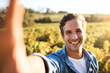 © Stratford/peopleimages.com - Portrait, selfie and happy man at farm for agriculture, growth or gardening in nature. Face, picture and smile farmer at field in countryside for sustainability, production and agro outdoor in Italy