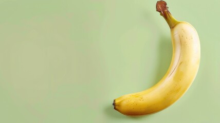 Wall Mural - Ripe banana on light green background, ready to eat