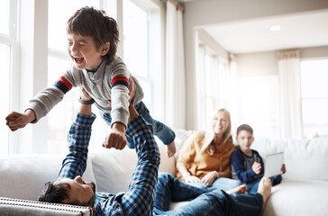 Wall Mural - Daddy, son and airplane in home or laughing, love and support for flying game in lounge. Family, father and boy play superhero together in living room, happiness and childhood for trust connection