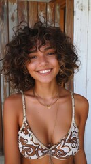 Wall Mural - Young Brazilian woman with curly hair, looking joyful