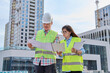 © Valerii Honcharuk - Two industrial construction workers discussing project plan for engineering work