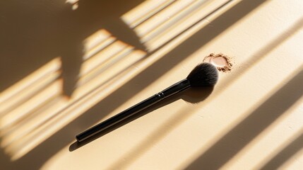 Wall Mural - Makeup brush beside open tube on beige background with sunlight shadows empty space for text makeup backdrop