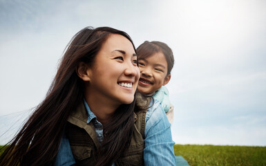 Wall Mural - Happy mom, kid and piggyback with freedom in nature for bonding, holiday or outdoor weekend. Asian mother carry girl, child or daughter with smile for adventure, embrace or childhood at park outside