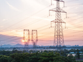 power pylons in field at sunset