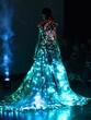 © Bendix - Woman Modeling Illuminated Blue and Pink Dress on Runway