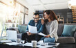 © ClearConcept/peopleimages.com - Laughing, budget documents or happy couple with financial paperwork and planning savings in home. Funny joke, smile or people organizing bills checklist for paying debt, finance or household expenses