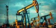 © Anastasiia - Distant photo of modern oil pumpjacks extracting raw oil from the ground. Concept Oil Extraction, Pumpjacks, Industrial Technology, Fossil Fuel, Energy Production