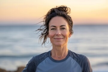 Wall Mural - Portrait of a satisfied woman in her 40s wearing a moisture-wicking running shirt on tranquil ocean backdrop