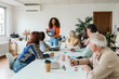 © ADDICTIVE STOCK - Diverse team collaborating in a bright coworking space