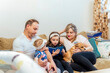 © ADDICTIVE STOCK - Family enjoying time together at home with a dog