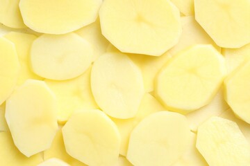Sticker - Cut fresh raw potatoes as background, top view