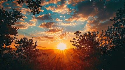Wall Mural - A beautiful sunset with a bright sun shining through the trees. The sky is filled with clouds, creating a serene and peaceful atmosphere