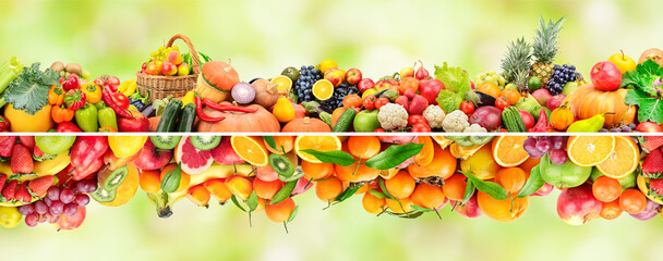 Wall Mural - Bright collection ripe fruits, vegetables and berries on green background.